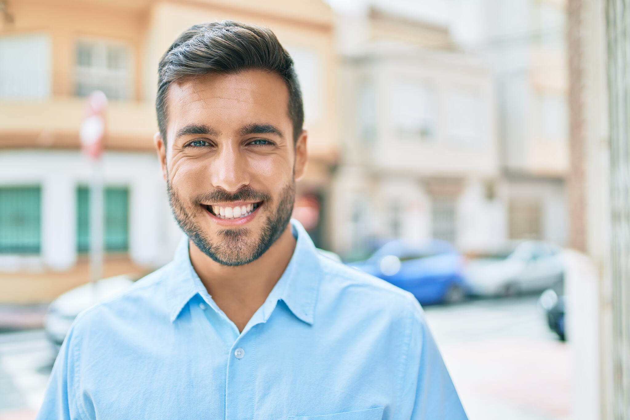 Young,Hispanic,Man,Smiling,Happy,Standing,At,Street,Of,City.