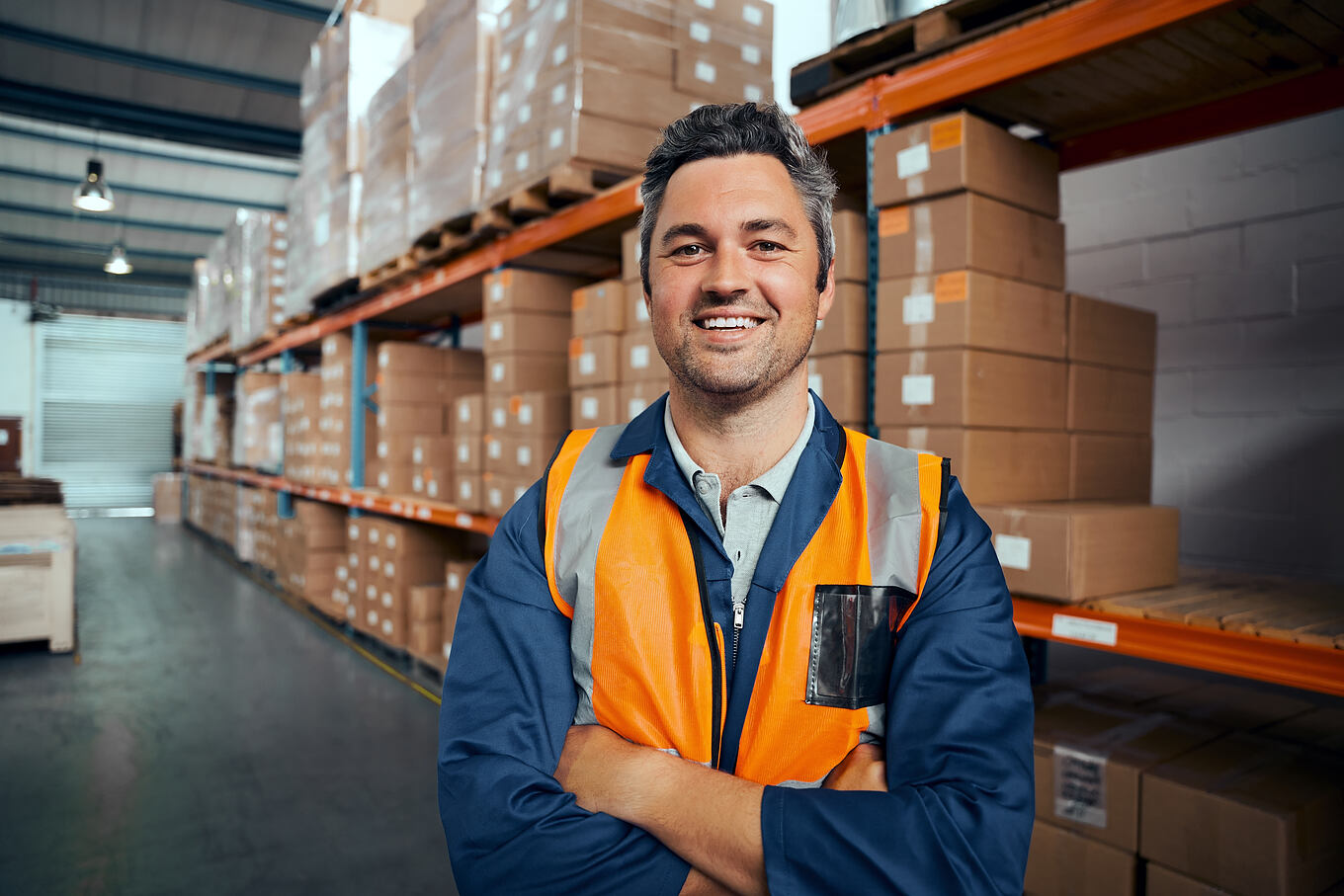 Smiling,Portrait,Of,A,Male,Supervisor,Standing,In,Warehouse,With